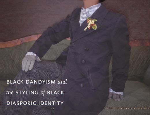 Book cover of Slaves to Fashion: Black Dandyism and the Styling of Black Diasporic Identity by Monica L. Miller. The cover features a stylishly dressed Black man in a double-breasted suit with a flower boutonnière, sitting on a vintage green couch in a confident, posed manner.