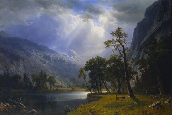 A luminous landscape painting of Yosemite Valley by Albert Bierstadt, showing towering granite cliffs, sunlit clouds breaking over a mountain range, and two small figures with a horse beside a reflective river in the foreground.