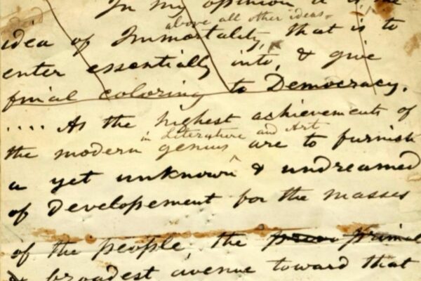 Handwritten manuscript page by Walt Whitman with cursive text discussing democracy and literature.
