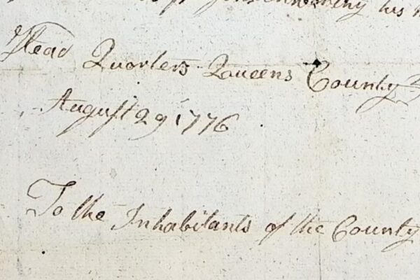 Close-up of a handwritten document dated August 29, 1776, from Queens County. The text reads in part “Head Quarters Queens County August 29, 1776” and begins “To the Inhabitants of the County,” written in cursive ink on aged paper.
