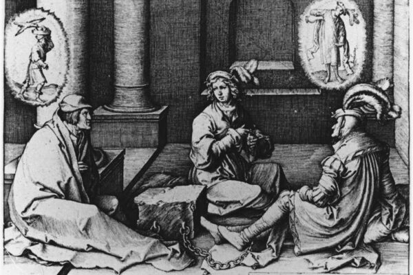 A black and white engraving from 1512 depicting three figures seated on the floor of a prison cell, their feet bound by a chain. The central figure, Joseph, gestures toward two other prisoners as he interprets their dreams. Above each prisoner's head floats a circular vision — one showing a figure carrying a basket, the other showing a figure being hanged. The scene is rendered in fine crosshatched lines characteristic of early sixteenth-century Northern European printmaking, with classical columns framing the background.
