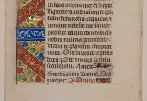 Illuminated manuscript page with Latin text and a large decorative initial featuring floral and geometric patterns in red, blue, and gold.